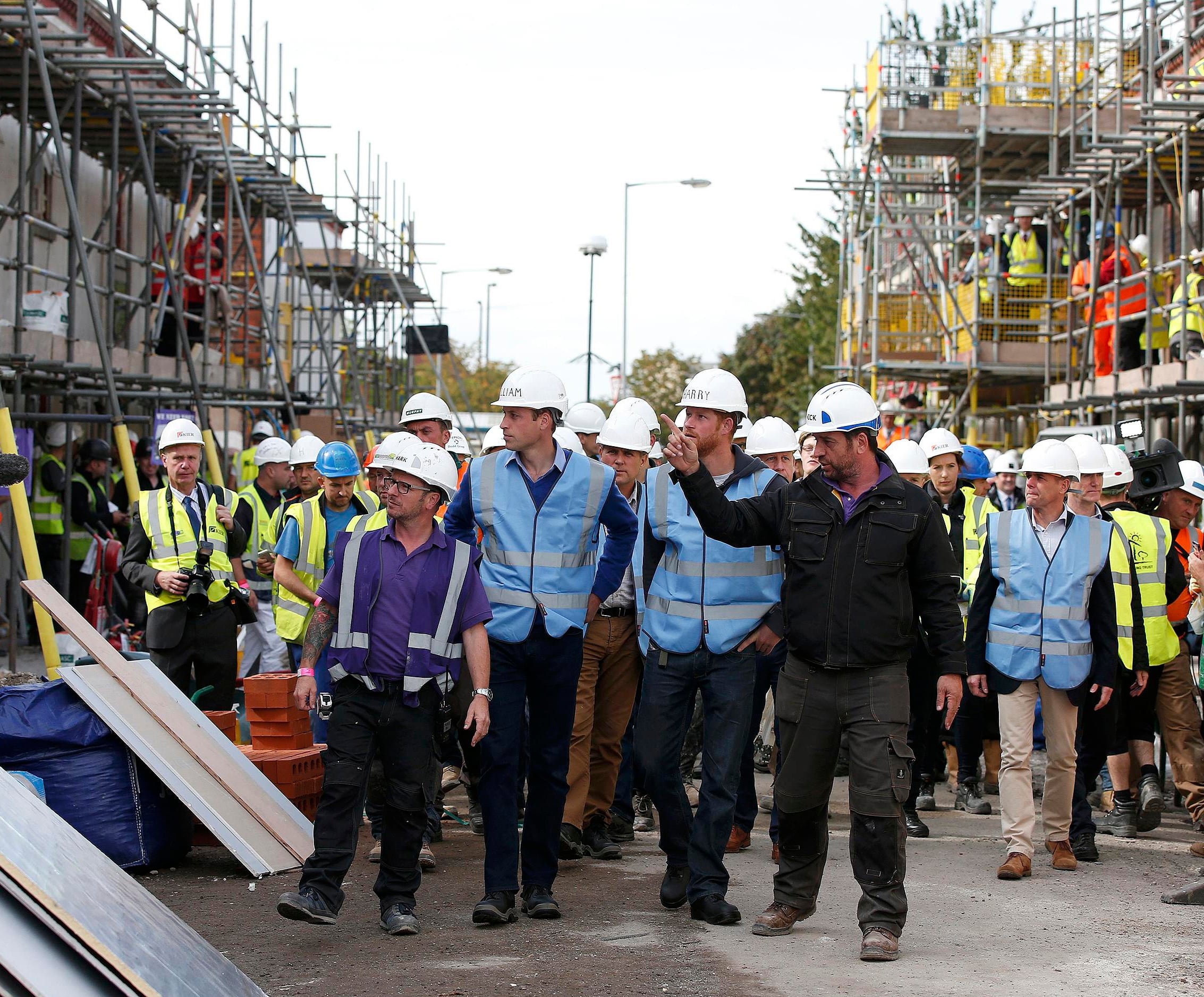 MANCHESTER, UNITED KINGDOM - SEPTEMBER 23: Prince William, Duke of Cambridge and Prince Harry tour a building site as work continues to help renovate homes for ex-service personnel as part of the BBC television DIY SOS series on September 23, 2015 in Manchester, England. Prince William and Prince Harry visited Manchester on Wednesday where they helped to renovate homes for ex-service personnel as part of the BBC television DIY SOS series. (Photo by Phil Noble - WPA Pool/Getty Images)